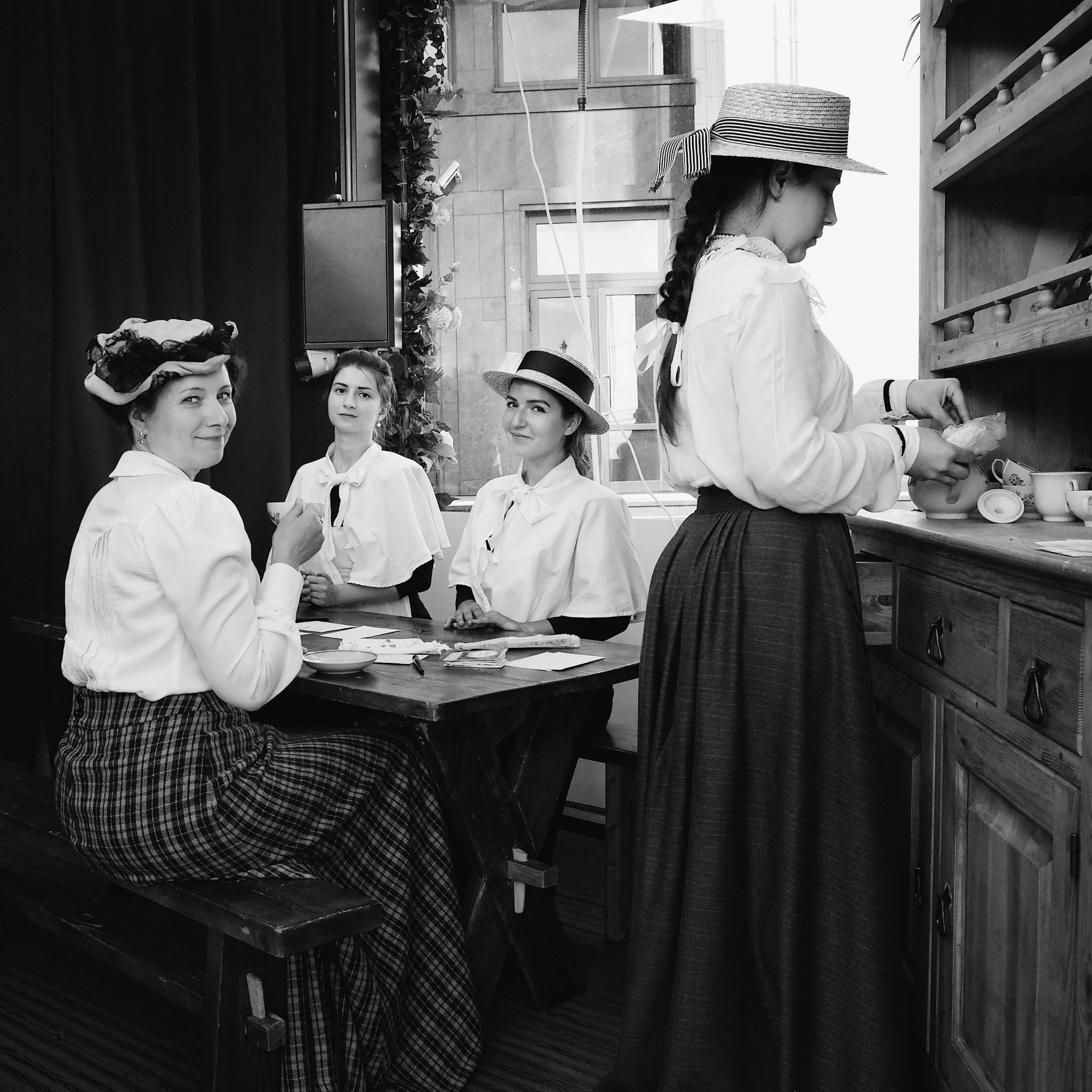 Women seated together around a table, illustrative black-and-white photograph